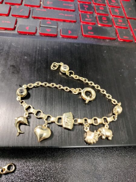 manilla c/5charms elef.delfin,cartera,coraz,caracol 14k zirc B Size size8/3mm Weight 7.75gr