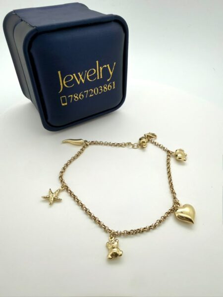 bracelet Bracelet with assorted charms. 10k Size Weight 2.9gr